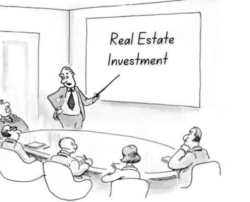 A meeting scene with individuals seated around a table, while one person stands and presents a real estate investment in the context of audits of registered plan strips (John Scholz) - KR Law Firm - Tax Law Firm in Toronto